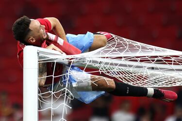 El jugador de Quilmes, Lucas Ocampos, subido a una de las porterías del Puskás Aréna.