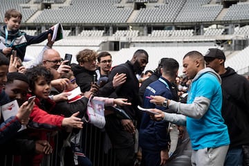 Paris Saint-Germain's Kylian Mbappé signs autographs after taking part in a football match with children from the "Premiers de Cordee" association at the Stade de France in Saint-Denis, north of Paris, on April 12, 2023.