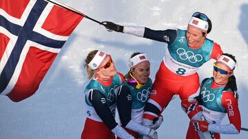 Norway's Marit Bjoergen (2nd R) is carried by her teammates after winning the women's 30km cross country mass start classic at the Alpensia cross country ski centre during the Pyeongchang 2018 Winter Olympic Games in Pyeongchang on February 25, 2018. / AFP PHOTO / FRANCK FIFE