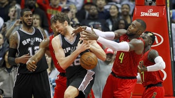 Jan 1, 2017; Atlanta, GA, USA; San Antonio Spurs center Pau Gasol (16) fights for a loose ball with Atlanta Hawks forward Paul Millsap (4) in the fourth quarter at Philips Arena. The Hawks won 114-112 in overtime. Mandatory Credit: Brett Davis-USA TODAY Sports