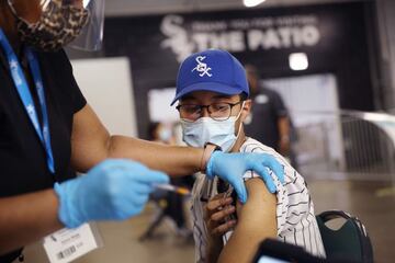 Christian Santos receives a COVID-19 vaccine at Guaranteed Rate Field