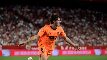 Valencia's Spanish midfielder #8 Javi Guerra celebrates scoring his team's second goal during the Spanish Liga football match between Sevilla FC and Valencia CF at the Ramon Sanchez Pizjuan stadium in Seville on August 11, 2023. (Photo by CRISTINA QUICLER / AFP)