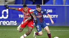 HUESCA, SPAIN - FEBRUARY 21: Javi Galan of SD Huesca battles for possession with Kenedy of Granada CF during the La Liga Santander match between SD Huesca and Granada CF at Estadio El Alcoraz on February 21, 2021 in Huesca, Spain. Sporting stadiums around