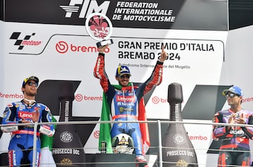 MotoGP - Italian Grand Prix - Mugello Circuit, Scarperia e San Piero, Italy - June 2, 2024 Ducati Lenovo Team's Francesco Bagnaia celebrates with a trophy on the podium after winning the race alongside second place Ducati Lenovo Team's Enea Bastianini and third place Prima Pramac Racing's Jorge Martin REUTERS/Jennifer Lorenzini