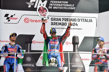 MotoGP - Italian Grand Prix - Mugello Circuit, Scarperia e San Piero, Italy - June 2, 2024 Ducati Lenovo Team's Francesco Bagnaia celebrates with a trophy on the podium after winning the race alongside second place Ducati Lenovo Team's Enea Bastianini and third place Prima Pramac Racing's Jorge Martin REUTERS/Jennifer Lorenzini