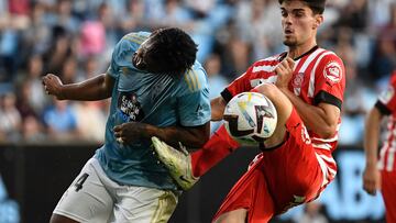 Celta Vigo's Peruvian midfielder Renato Tapia (L) fights for the ball with Girona's Spanish defender Miguel Gutierrez during the Spanish league football match between RC Celta de Vigo and Girona FC at the Balaidos stadium in Vigo on May 23, 2023. (Photo by MIGUEL RIOPA / AFP)