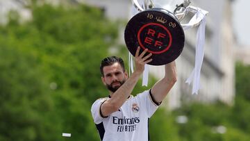 Real Madrid's Spanish defender #06 Nacho Fernandez holds their 36th Liga as Real Madrid' players parade onboard a bus during celebration at the Cibeles square in Madrid on May 12, 2024. Real Madrid's fans line the streets of Madrid as 'Los blancos' celebrate their 36th Liga trophy before facing Borussia Dortmund at Wembley in the Champions League final on June 1. (Photo by OSCAR DEL POZO / AFP)