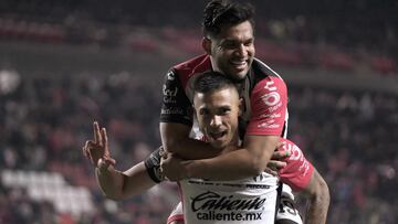 Atlas' Montenegrin forward #32 Uros Durdevic (bottom) celebrates with teammate forward #19 Eduardo Aguirre after scoring a last minute winner during the Liga MX Clausura football match between Tijuana and Atlas at the Estadio Caliente in Tijuana, baja California state, Mexico on March 9, 2025. (Photo by Guillermo Arias / AFP)
