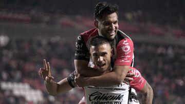 Atlas' Montenegrin forward #32 Uros Durdevic (bottom) celebrates with teammate forward #19 Eduardo Aguirre after scoring a last minute winner during the Liga MX Clausura football match between Tijuana and Atlas at the Estadio Caliente in Tijuana, baja California state, Mexico on March 9, 2025. (Photo by Guillermo Arias / AFP)