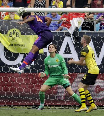 Liverpool's Virgil van Dijk (4) heads the ball past Borussia Dortmund goalkeeper Marwin Hitz (35) during an International Champions Cup tournament soccer match in Charlotte, N.C., Sunday, July 22, 2018. (AP Photo/Chuck Burton)