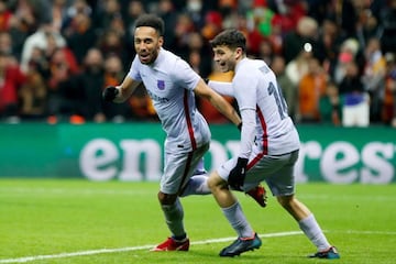 Barcelona's Gabonese midfielder Pierre-Emerick Aubameyang (L) celebrates with Barcelona's Spanish midfielder Pedri after scoring a goal during the UEFA Europa League round of 16 secong leg football match between Galatasaray and Barcelona at the Ali Sami Y