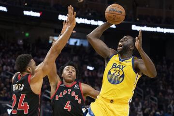 November 21, 2021; San Francisco, California, USA; Golden State Warriors forward Draymond Green (23) shoots the basketball against Toronto Raptors center Khem Birch (24) and forward Scottie Barnes (4) during the third quarter at Chase Center. Mandatory Cr