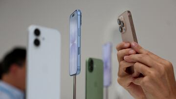 A person uses a phone to capture iPhones on display during Apple's event at the Steve Jobs Theater in Cupertino, California, U.S. September 9, 2025. REUTERS/Manuel Orbegozo