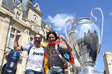 Seguidores del Real Madrid se fotografían con una réplica de 'La Orejona'.