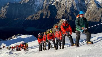 In this handout photograph taken on October 4, 2020 and released by the Seven Summits Treks, an 18-member party of the Bahrain Royal Guard mountaineering team including a Bahraini prince and three Britons pose as they head to summit Mount Lobuche East, 6,119-metre high northeast of Kathmandu. - A mountaineering team including a Bahraini prince completed the first summit this autumn season of a Himalayan peak in Nepal, after the government made an exception to a coronavirus ban on foreign arrivals. (Photo by Tashi Lakpa Sherpa / Seven Summit Treks / AFP) / -----EDITORS NOTE --- RESTRICTED TO EDITORIAL USE - MANDATORY CREDIT "AFP PHOTO / Tashi Lakpa Sherpa / Seven Summit Treks" - NO MARKETING - NO ADVERTISING CAMPAIGNS - DISTRIBUTED AS A SERVICE TO CLIENTS - NO ARCHIVES