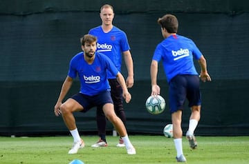 Barcelona's German goalkeeper Marc-Andre Ter Stegen (back) and Barcelona's Spanish defender Gerard Pique take part in the football club's first pre-season training session at the Joan Gamper training ground in Sant Joan Despi near Barcelona on July 15, 20