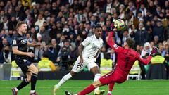 MADRID, SPAIN - JANUARY 29: Alex Remiro of Real Sociedad makes a save from Vinicius Junior of Real Madrid during the LaLiga Santander match between Real Madrid CF and Real Sociedad at Estadio Santiago Bernabeu on January 29, 2023 in Madrid, Spain. (Photo by Angel Martinez/Getty Images)