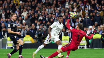 MADRID, SPAIN - JANUARY 29: Alex Remiro of Real Sociedad makes a save from Vinicius Junior of Real Madrid during the LaLiga Santander match between Real Madrid CF and Real Sociedad at Estadio Santiago Bernabeu on January 29, 2023 in Madrid, Spain. (Photo by Angel Martinez/Getty Images)