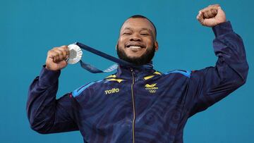 Silver medallist Colombia's Yeison Lopez celebrates on the podium after the men's -89kg weightlifting event during the Paris 2024 Olympic Games at the South Paris Arena in Paris, on August 9, 2024. (Photo by Dimitar DILKOFF / AFP)