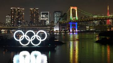 The Olympic rings (L) are displayed off the shore of the Odaiba Marine Park during the Tokyo 2020 Year Commemorative Ceremony in Tokyo on January 24, 2020, to mark six months before the opening of the Tokyo 2020 Olympic Games. - Tokyo&#039;s governor Yuriko Koike on January 24 wooed further support for a success of the Tokyo Olympics, as fireworks lit up the night sky to celebrate six months until the 2020 opening ceremony. (Photo by Kazuhiro NOGI / AFP)