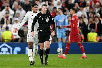 Real Madrid's English midfielder #05 Jude Bellingham protests against decision made by Referee Francois Letexier during the UEFA Champions League football match between Liverpool and Real Madrid at Anfield in Liverpool, north west England on November 27, 2024. (Photo by Oli SCARFF / AFP)