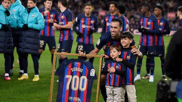 (FILES) In this file photo taken on January 22, 2023 Barcelona's Spanish midfielder Sergio Busquets poses for pictures with a jersey reading "700" after playing more than 700 matches with FC Barcelona, before the start of the Spanish league football match between FC Barcelona and Getafe CF at the Camp Nou stadium in Barcelona. Sergio Busquets will leave Barcelona in June at the end of his contract, the midfielder confirmed on May 9, 2023 ending a highly successful era at the club. The 34-year-old was a central figure in Barcelona's golden era winning a host of trophies including the Champions League three times. (Photo by Josep LAGO / AFP)