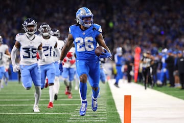 Jahmyr Gibbs of the Detroit Lions celebrates while scoring a rushing touchdown against the Tennessee Titans at Ford Field on October 27, 2024.