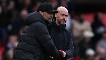 Liverpool's German manager Jurgen Klopp (L) and Manchester United's Dutch manager Erik ten Hag (R) shake hands on the final whistle in the English Premier League football match between Manchester United and Liverpool at Old Trafford in Manchester, north west England, on April 7, 2024. The game finished 2-2. (Photo by Paul ELLIS / AFP) / RESTRICTED TO EDITORIAL USE. No use with unauthorized audio, video, data, fixture lists, club/league logos or 'live' services. Online in-match use limited to 120 images. An additional 40 images may be used in extra time. No video emulation. Social media in-match use limited to 120 images. An additional 40 images may be used in extra time. No use in betting publications, games or single club/league/player publications. / 