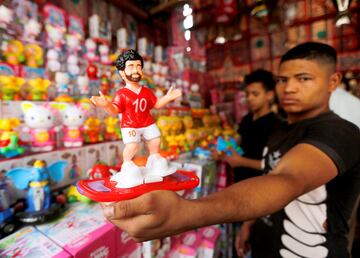 A man displays a toy figure bearing the image of Liverpool's Egyptian forward soccer player Mohamed Salah, are seen at a market, before the beginning of the holy fasting month of Ramadan in Cairo, Egypt May 2, 2018.