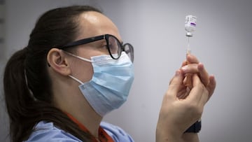 A member of the vaccine team prepares a syringe with a dose of the AstraZeneca/Oxford Covid-19 vaccine, at an NHS Scotland vaccination centre set up at the Edinburgh International Conference Centre (EICC) in Edinburgh on February 1, 2021. - Britain is under a third national lockdown as it battles a new strain of the virus and has recorded more than 106,000 deaths from the disease -- the worst toll in Europe. (Photo by Jane Barlow / POOL / AFP)