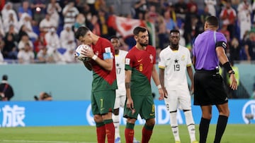 DOHA, QATAR - NOVEMBER 24: Cristiano Ronaldo of Portugal kisses the ball as they prepare to take a penalty during the FIFA World Cup Qatar 2022 Group H match between Portugal and Ghana at Stadium 974 on November 24, 2022 in Doha, Qatar. (Photo by Clive Brunskill/Getty Images)