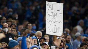 Dec 19, 2021; Detroit, Michigan, USA; A fan holds up a Christmas sign during the fourth quarter in the game between the Detroit Lions and the Arizona Cardinals at Ford Field. Mandatory Credit: Raj Mehta-USA TODAY Sports