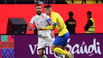 Fayha's Saudi defender #33 Hussein al-Shuwaish fights for the ball with Nassr's Portuguese forward #07 Cristiano Ronaldo during the AFC Champions League football match between Saudi Arabia's Al-Nassr and Saudi Arabia�s Al-Fayha at the Al-Awwal Park Stadium in Riyadh on February 21, 2024. (Photo by Fayez NURELDINE / AFP)