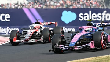Alpine's Argentine driver Franco Colapinto (R) drives past Haas F1 Team's French driver Esteban Ocon during the qualifying session ahead of the Formula One Japanese Grand Prix at the Suzuka circuit in Suzuka, Mie prefecture on March 28, 2026. (Photo by Toshifumi KITAMURA / AFP)