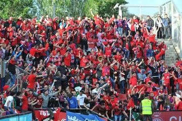 The protective barrier can be seen giving way as the Osasuna fans celebrate.