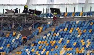 Labourers carry panels as they work inside The NSC Olimpiyskiy Stadium in Kiev on May 14, 2018, ahead of the 2018 UEFA Champions League Final football match between Liverpool and Real Madrid.
Kiev is preparing for the 2018 UEFA Champions League Final which will be played at the NSC Olimpiyskiy Stadium on May 26, 2018, and for the 2017-18 UEFA Women's Champions League final which will be played at Valeriy Lobanovskiy Dynamo Stadium on May 24.  / AFP PHOTO / Sergei SUPINSKY