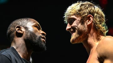 Former world welterweight king Floyd Mayweather (L) and YouTube personality Logan Paul face-off during their weigh-in event in Miami, Florida on June 5, 2021. - Former world welterweight king Floyd Mayweather said May 4, 2021 he will face off against YouT