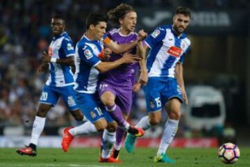 Modric between Javi López and David López.