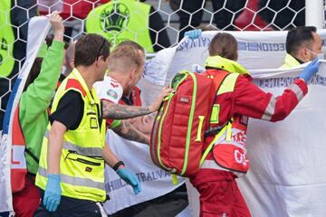 El jugador dan¨¦s, ya consciente, es retirado en camilla para ser trasladado al hospital.