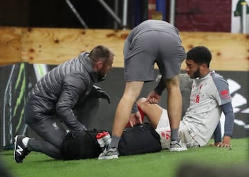 Liverpool's Joe Gomez has his ankle seen to at Turf Moor