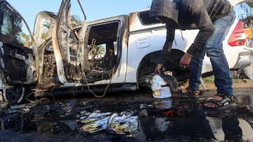 A Palestinian inspects near a vehicle where employees from the World Central Kitchen (WCK), including foreigners, were killed in an Israeli airstrike, according to the NGO as the Israeli military said it was conducting a thorough review at the highest levels to understand the circumstances of this "tragic" incident, amid the ongoing conflict between Israel and Hamas, in Deir Al-Balah, in the central Gaza, Strip April 2, 2024. REUTERS/Ahmed Zakot     TPX IMAGES OF THE DAY