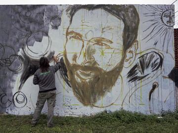 Un artista pinta un mural en homenaje a Leo Messi cerca del lugar del enlace de la estrella del fútbol con Antonella Rocuzzo.