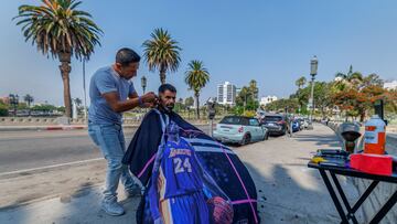 Barber Beraldo Gabaldon of Los Angeles cuts the hair of the homeless.