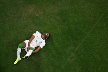 Saudi Arabia's defender #05 Ali Al-Bulaihi gestures on the ground during the Qatar 2022 World Cup Group C football match between Saudi Arabia and Mexico at the Lusail Stadium in Lusail, north of Doha on November 30, 2022. (Photo by MANAN VATSYAYANA / AFP) (Photo by MANAN VATSYAYANA/AFP via Getty Images)