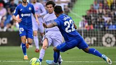 Barcelona&#039;s Spanish midfielder Riqui Puig (L) fights for the ball with Getafe&#039;s Uruguayan defender Damian Suarez during the Spanish league football match between Getafe CF and FC Barcelona at the Col. Alfonso Perez stadium in Getafe on May 15, 2