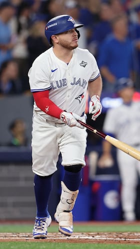 TORONTO, ONTARIO - OCTOBER 25: Alejandro Kirk #30 of the Toronto Blue Jays hits a sacrifice fly to score a run against the Los Angeles Dodgers during the third inning in game two of the 2025 World Series at Rogers Center on October 25, 2025 in Toronto, Ontario.   Emilee Chinn/Getty Images/AFP (Photo by Emilee Chinn / GETTY IMAGES NORTH AMERICA / Getty Images via AFP)