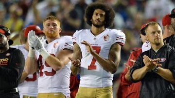 Sep 1, 2016; San Diego, CA, USA;  San Francisco 49ers quarterback Colin Kaepernick (7) and fullback Bruce Miller (49) applaud as the San Diego Chargers honor military service members during the second quarter at Qualcomm Stadium. Mandatory Credit: Jake Roth-USA TODAY Sports