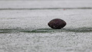 FOXBOROUGH, MASSACHUSETTS - JANUARY 07: A football is seen in the snow during a game between the New York Jets and New England Patriots at Gillette Stadium on January 07, 2024 in Foxborough, Massachusetts.   Winslow Townson/Getty Images/AFP (Photo by Winslow Townson / GETTY IMAGES NORTH AMERICA / Getty Images via AFP)