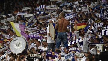 A Real Madrid's fan plays with a drum during the UEFA Champions League football match at the Santiago Bernabeu stadium in Madrid