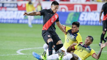 Raul Ruidiaz from Peru (L) jumps over Xavier Arreaga (C) and Dario Aimar (R) from Ecuador during the international friendly football match between Ecuador and Peru at the Red Bull Arena in Harrison, New Jersey on September 5, 2019. (Photo by Kena Betancur